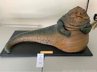 Front view of entire figurine on base, showing size and pose