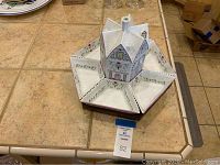 Top-down view of Lazy Susan server showing porcelain house centerpiece and six triangular dishes on wood base