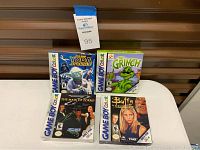 Four boxed Game Boy Color games displayed on table, showing front cover artwork and rating E for Everyone.