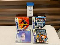 Photo showing four Game Boy Color game boxes: Mission Impossible, X-Men Mutant Academy, MIB Men in Black The Series, and X-Men Mutant Wars.