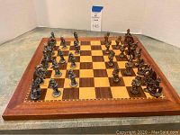 Board set up with all pewter fantasy pieces arranged