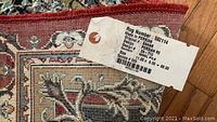 Close-up image of the rug label showing details about the rug's origin, size, and material.