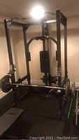 Front view of assembled Weider multi-station machine with lat pulldown bar attached and bench in place