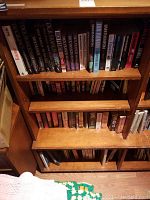 Bookshelves with mostly mystery and thriller novels including Dick Francis, Ian Rankin, John Grisham, and others