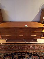 Front elevation view of teak dresser showing full width and drawer configuration.