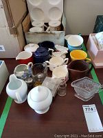Overview of assorted coffee mugs, sugar bowls and creamers, showing a variety of colors and materials.