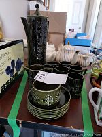 Full 16-piece Portmeirion 'Totem' tea set with teapot, cups, saucers, creamer, and sugar bowl displayed on a table.