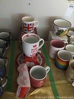Overview of mugs including Keep Calm mugs and Union Jack mug with surrounding cups