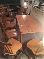 Full set showing rectangular pine wood table and six chairs arranged around it
