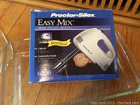 Proctor Silex Easy Mix hand mixer in original packaging showing product details and condition.