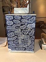 Front view of the rectangular ginger jar with blue and white dragon and cloud pattern.