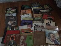 Overview of all vinyl albums laid on the floor showing various titles and cover art representing world music, classical, and folk.