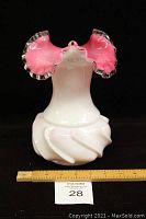 Front and side view of Fenton Silvercrest pink ruffled edge glass vase on black background with ruler for scale.
