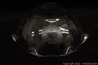 Large clear crystal bowl with ruffled edges and Cornflower pattern, shown on dark background.