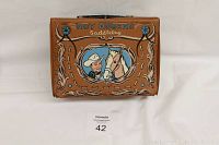 Front view of vintage Roy Rogers saddlebag lunchbox showing Roy Rogers and horse illustration in brown vinyl.