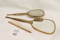 Full view of the vintage vanity three-piece set showing hand mirror, brush and comb on a white background with lot number card.