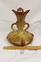 Front view of vintage amber-colored Seewai pottery vase with ruler showing scale.