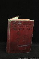 Front cover of Hardcover 'Honey Bunch: Her First Trip on the Great Lakes' book showing red cloth cover with black title text and visible wear and scratches.