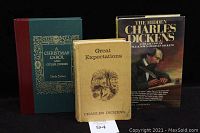 Lot of three hardcover Charles Dickens novels shown together: 'A Christmas Carol and Other Stories', 'Great Expectations', and 'The Hidden Charles Dickens'.