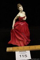 Front view of the Royal Doulton 'Innocence' figurine standing next to a ruler showing approximately 7.5 inches tall.