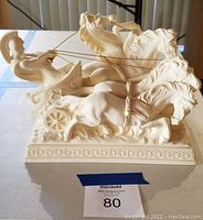 Front and side views of the gladiator statue featuring the four horses and chariot detailing.