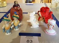 Photo of vintage pin cushions and china half dolls on display