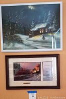 Framed Grace Harvey oil painting of snowy cabin on top, and framed Thomas Kincade print with scripture and certificate below, showing full lot