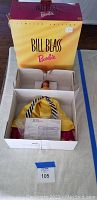 Bill Blass Barbie doll in original box with yellow and pink packaging visible.