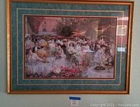 Framed print showing a garden party scene with many people seated at tables, gold-tone frame with green mat board.