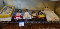 Six Effanbee dolls on shelf, includes one boxed doll, dolls dressed in various period and cultural costumes, sizes range from 8.5 to 17 inches tall.