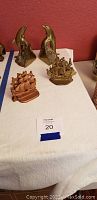 Photo of the full lot with both pairs of bookends including brass dolphins and two ship models.