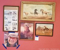 Five western-themed prints on red wall, including horses, John Wayne portraits, cowboy with bucking horse, and western movie advertisement.