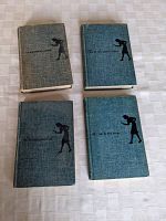 Four Nancy Drew hardcover books laid flat on a light surface showing front covers with titles and silhouette graphics.