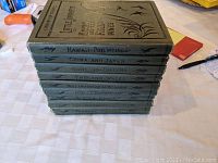 Stack of 10 hardcover travel books with titles visible on spines including Hawaii and the Philippines, China and Japan, Scotland and Ireland, England and Wales, Holland Belgium Denmark, France Switzerland, Alaska Canada, Germany, Turkey The Balkans and Greece.