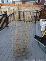 Full view of the wire tower display rack showing its height and multiple rows of compartments for displaying items such as books or cards.