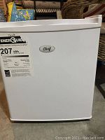 Front view of white mini fridge with Master Chef logo and energy guide label.