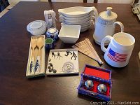 Overall lot showing all items: exercise balls, tealight holder, dishes, teapot, salad tongs, cheese grater, ceramic plate with jewelry, and fans.