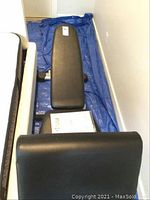Full-length view of adjustable bench on blue tarp, showing back pad and seat pad