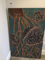 Full view of octopus painting leaning against wall, showing the entire artwork and size.
