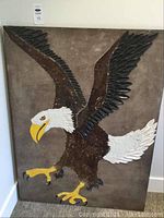 Full view of the eagle painting showing the entire artwork mounted on the wall.