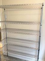Full frontal view of the empty metal shelving unit showing all six shelves and overall structure.
