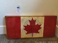Full view of wooden panel art showing Canadian flag with peace symbol on cream background and red sides.