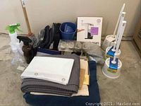 Overview photo showing all items including towels, cleaning sprays, SimpleHuman dispenser box, and toilet brushes