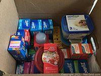 Top view showing mixed boxes of Ziplock sandwich bags, Glad garbage bags, Surefresh storage bags, Betty Crocker container, and Surefresh plastic food storage containers