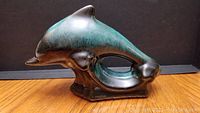 Side angled view of the dolphin figurine showing detailed glazing and shape