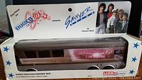 Photo showing Sawyer Brown Super Friction Powered Bus bank in original packaging with visible label and band photo.