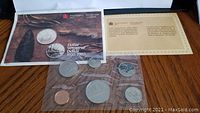 Set of Canadian coins in original RCM packaging displayed with informational booklet and certificate