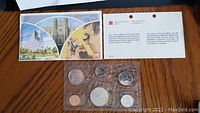 1981 uncirculated Canadian coin set in original packaging including six coins in plastic sleeve and informational pamphlet showing Canadian landmarks.