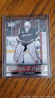 Front of the John Gibson rookie card showing player in goalie position, Young Guns branding and player name.