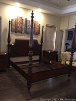 Full view of bed frame without mattress or box springs, showing side rails and center support